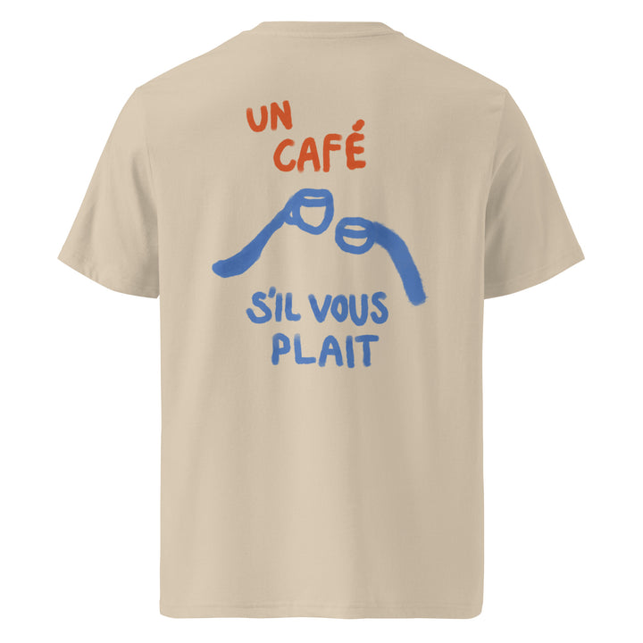 Un Cafe S'il Vous Plait Organic T-shirt featuring a stylish design with café-related graphics on a beige background.