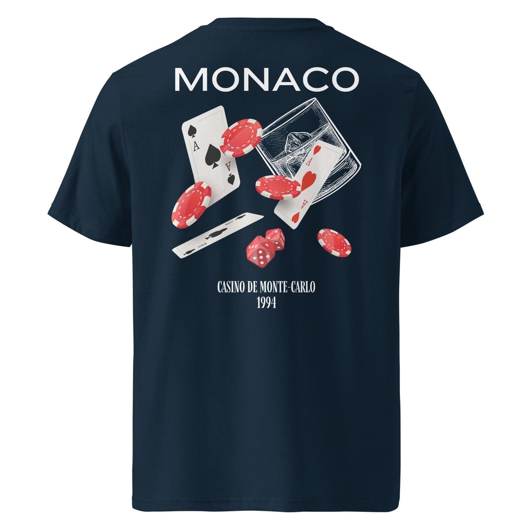 The Tequila & Sunrise Monaco Casino de Monte-Carlo Organic T-shirt in navy blue features the "MONACO" text alongside a graphic of playing cards, poker chips, dice, and the Casino de Monte-Carlo 1994 design on the back. It serves as a stylish and eco-friendly choice suitable for all genders.