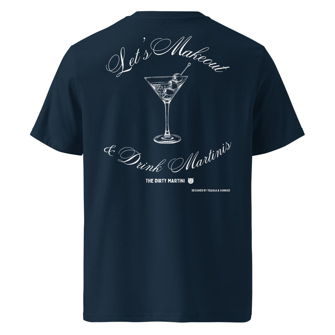 The Let's Makeout & Drink Martinis Organic T-shirt by Tequila & Sunrise is navy blue and made from organic cotton. It features white text that reads "Let’s Makeout & Drink Martinis," capturing the playful essence of the Naughty Martinis Club. The design includes a graphic of a martini glass with an olive, crafted using eco-friendly materials.