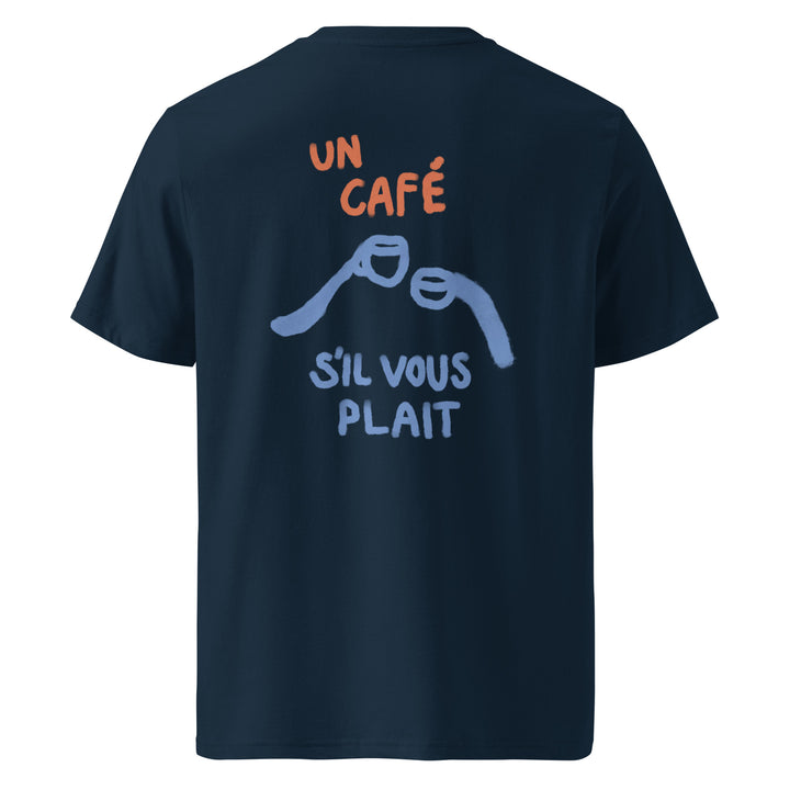 Back of The Un Cafe S'il Vous Plait Organic T-shirt by Tequila & Sunrise, an eco-friendly navy blue design showcasing orange and blue text that reads "UN CAFÉ SIL VOUS PLAIT," with two stylized coffee mugs clinking. Crafted from soft organic cotton, this unisex t-shirt offers a stylish tribute to your favorite beverage.