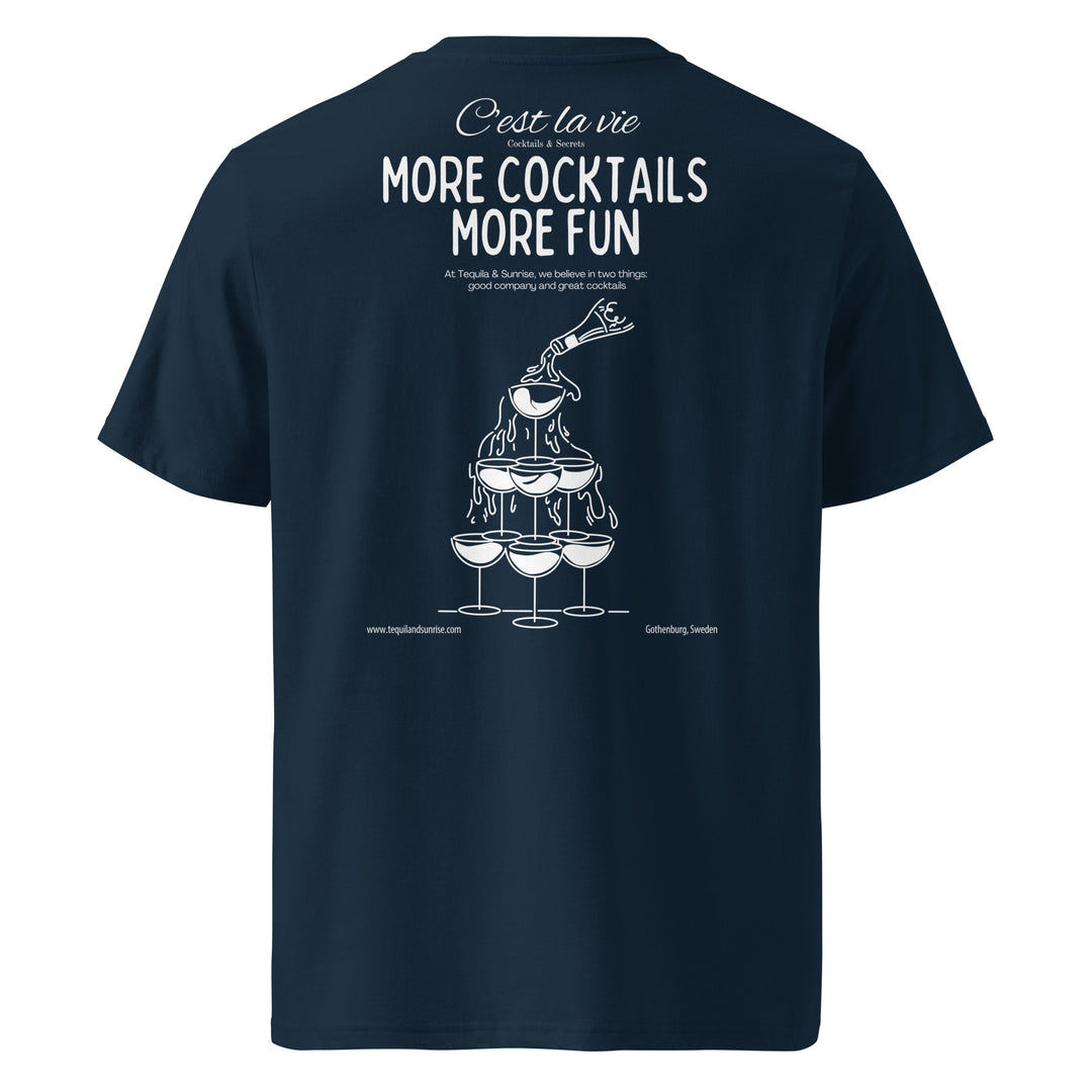 Introducing the "More Cocktails More Fun Organic T-shirt" by Tequila & Sunrise. This unisex navy blue T-shirt showcases a cocktail tower graphic alongside the playful phrase "C'est la vie, more cocktails more fun" in white text. Crafted from eco-friendly organic cotton, it offers stylish comfort with a conscience.