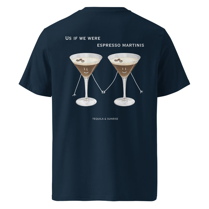 This unisex t-shirt, known as "The If We Were Espresso Martinis Organic T-shirt" by Tequila & Sunrise, is an eco-friendly choice made from organic cotton. It showcases two cartoon espresso martinis holding hands and smiling, accompanied by the text "Us if we were Espresso Martinis," above the brand name "Tequila & Sunrise." It's a playful addition for any cocktail enthusiast.