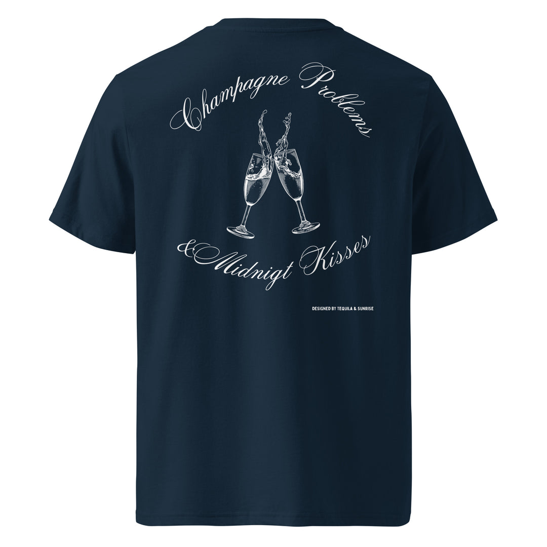 Champagne Problems & Midnight Kisses Organic T-shirt featuring champagne glasses on a navy background.