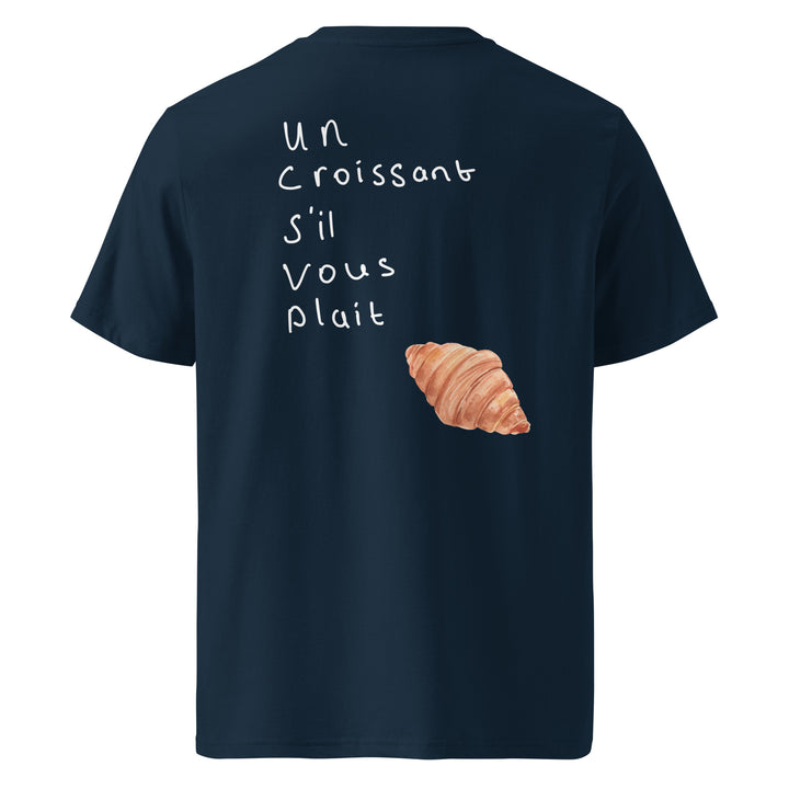 Un Croissant S’il Vous Plait Organic T-shirt with croissant graphic and French text on navy background.