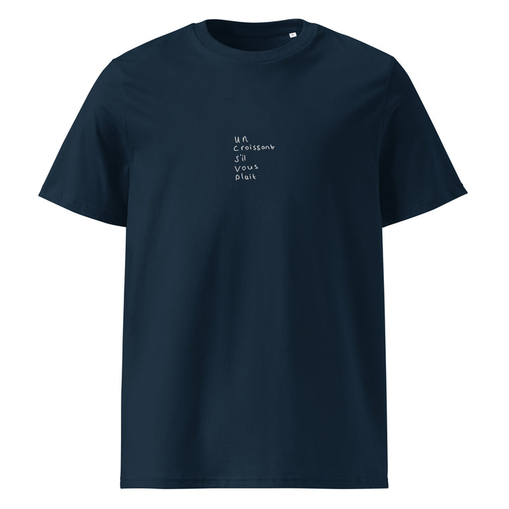 The Tequila & Sunrise "Un Croissant S’il Vous Plait" Organic T-shirt is a navy unisex tee crafted from organic cotton, showcasing the phrase "Un croissant s'il vous plaît" in small, white handwriting on the front.