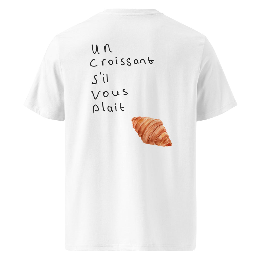 Introducing "The Un Croissant S’il Vous Plait Organic T-shirt" by Tequila & Sunrise, a white organic cotton t-shirt adorned with the handwritten text “Un Croissant Sil Vous Plaît” and a delightful croissant image. This eco-friendly, unisex piece seamlessly blends style and sustainability, making it perfect for a casual look.