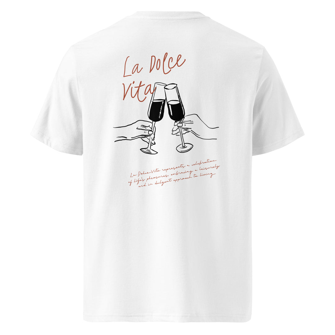 The La Dolce Vita Organic T-shirt by Tequila & Sunrise is crafted from organic cotton and showcases an illustration of two hands toasting with glasses, accompanied by the text "La Dolce Vita" in elegant red cursive. This item exemplifies unisex fashion while advocating for eco-friendly clothing choices.